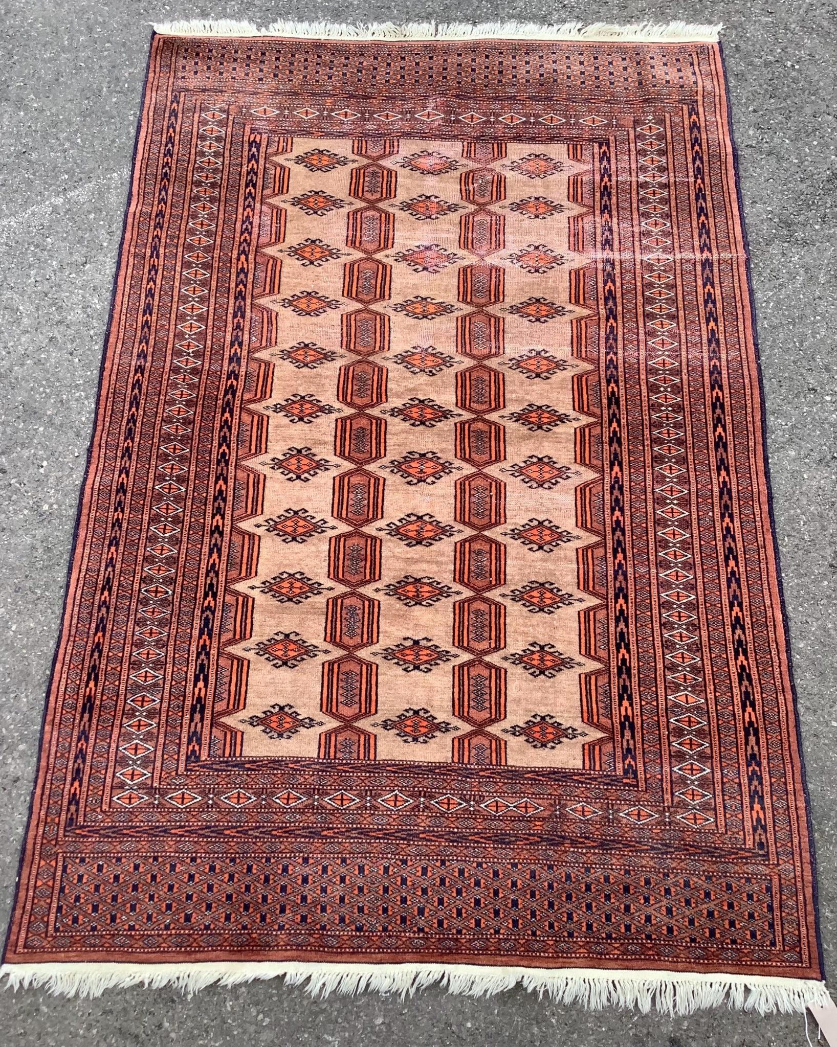 A Bokhara pale red ground rug, 185 x 122cm